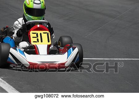 Person go-carting on a motor racing track View Large Photo Image Stock Image - Person go-carting on a motor racing track. Fotosearch