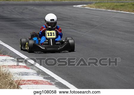 Person go-carting on a motor racing track View Large Photo Image Stock Photo - Person go-carting on a motor racing track. Fotosearch