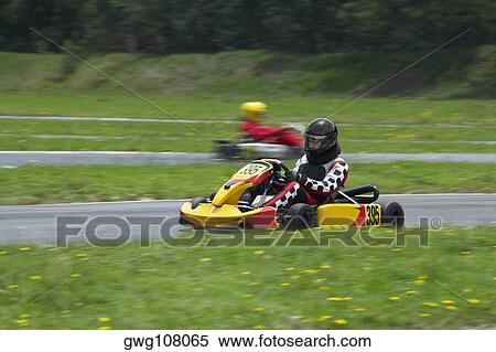Stock Photography - Person go-carting on a motor racing track. Fotosearch
