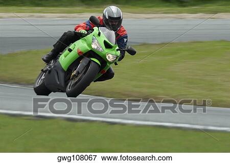 Person riding a motorcycle on a motor racing track View Large Photo Image Stock Photo - Person riding a motorcycle on a motor racing track. Fotosearch