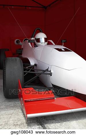 Racecar driver in a racecar under a shed View Large Photo Image Stock Image - Racecar driver in a racecar under a shed. Fotosearch