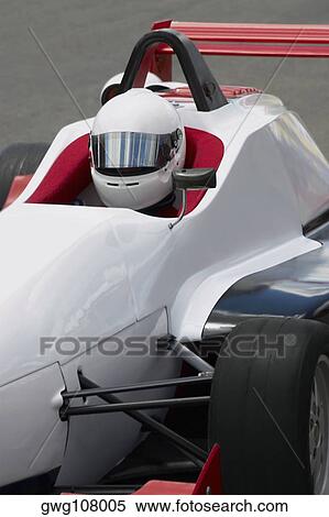 Racecar driver sitting in a racecar View Large Photo Image Stock Photography - Racecar driver sitting in a racecar. Fotosearch
