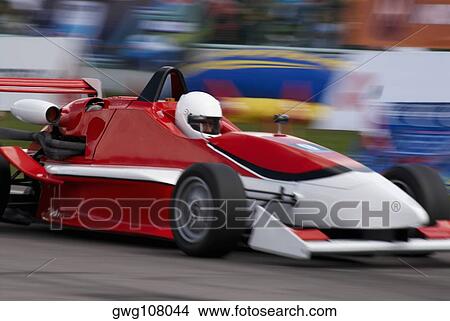 Racecar racing on a motor racing track View Large Photo Image Picture - Racecar racing on a motor racing track. Fotosearch
