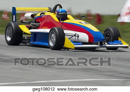 Racecar racing on a motor racing track View Large Photo Image Stock Image - Racecar racing on a motor racing track. Fotosearch
