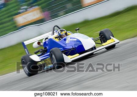 Racecar racing on a motor racing track View Large Photo Image Stock Image - Racecar racing on a motor racing track. Fotosearch