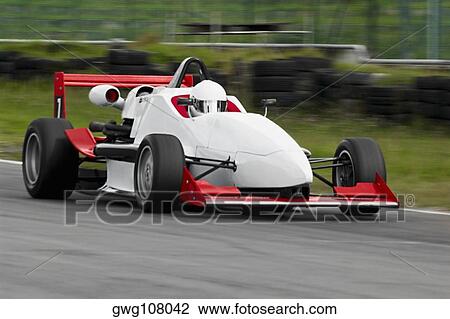 Racecar racing on a motor racing track View Large Photo Image Stock Image - Racecar racing on a motor racing track. Fotosearch