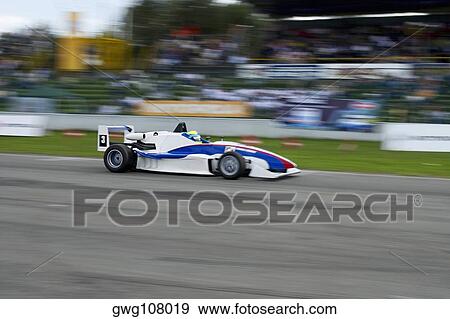 Racecar racing on a motor racing track View Large Photo Image Stock Photo - Racecar racing on a motor racing track. Fotosearch