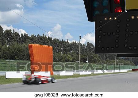 Racecar racing on a motor racing track View Large Photo Image Stock Photo - Racecar racing on a motor racing track. Fotosearch