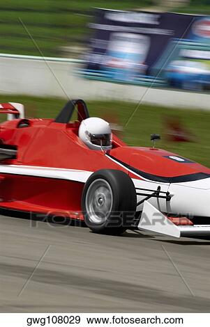 Racecar racing on a motor racing track View Large Photo Image Stock Photo - Racecar racing on a motor racing track. Fotosearch