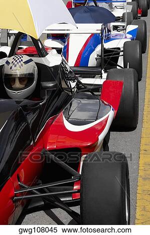 Row of racecars on a motor racing track View Large Photo Image Stock Photography - Row of racecars on a motor racing track. Fotosearch