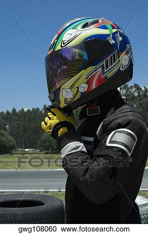 Side profile of a person adjusting his crash helmet View Large Photo Image Stock Image - Side profile of a person adjusting his crash helmet. Fotosearch