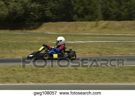 Side profile of a person go-carting on a motor racing track View Large Photo Image Stock Photo - Side profile of a person go-carting on a motor racing track. Fotosearch