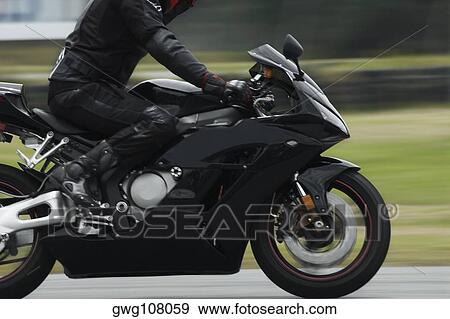 Side profile of a person riding a motorcycle View Large Photo Image Stock Photo - Side profile of a person riding a motorcycle. Fotosearch
