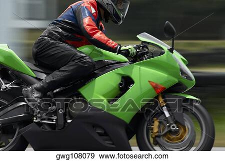Side profile of a person riding a motorcycle View Large Photo Image Stock Photo - Side profile of a person riding a motorcycle. Fotosearch