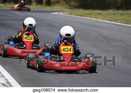 Two people go-carting on a motor racing track View Large Photo Image Picture - Two people go-carting on a motor racing track. Fotosearch