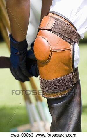 Close-up of a polo player tying riding boots View Large Photo Image Stock Image - Close-up of a polo player tying riding boots. Fotosearch