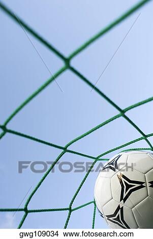 Close-up of a soccer ball in a goal post net View Large Photo Image Picture - Close-up of a soccer ball in a goal post net. Fotosearch