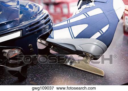 Stock Photo - Close-up of a sports helmet with an ice-skate. Fotosearch