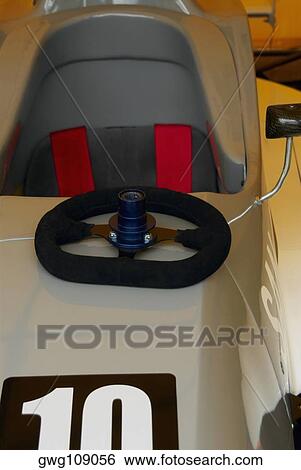 Close-up of a steering wheel on the hood of a racecar View Large Photo Image Stock Photograph - Close-up of a steering wheel on the hood of a racecar. Fotosearch