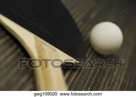 Stock Image - Close-up of a table tennis ball with a table tennis racket. Fotosearch