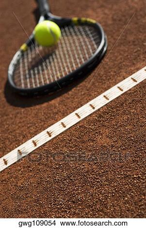 Close-up of a tennis ball on a racket in a court View Large Photo Image Picture - Close-up of a tennis ball on a racket in a court. Fotosearch