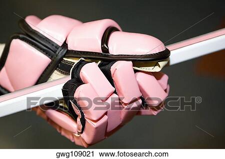 Close-up of an ice hockey player's hand holding an ice hockey stick View Large Photo Image Stock Image - Close-up of an ice hockey player's hand holding an ice hockey stick. Fotosearch