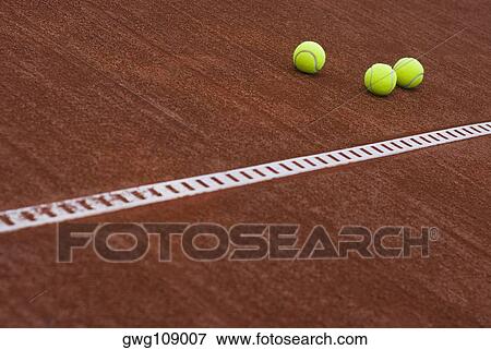 Close-up of three tennis balls in a court View Large Photo Image Stock Photo - Close-up of three tennis balls in a court. Fotosearch