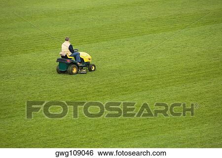 Side profile of a man mowing grass with a lawn mower in a field View Large Photo Image Stock Photograph - Side profile of a man mowing grass with a lawn mower in a field. Fotosearch