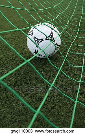 Close-up of a soccer ball in a goal post net View Large Photo Image Stock Image - Close-up of a soccer ball in a goal post net. Fotosearch