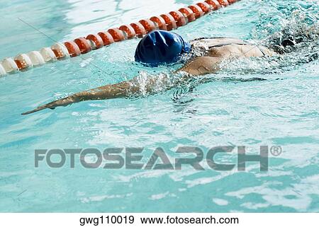 Close-up of a teenage girl swimming in a swimming pool View Large Photo Image Stock Photo - Close-up of a teenage girl swimming in a swimming pool. Fotosearch