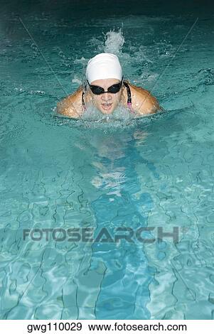Close-up of a teenage girl swimming in a swimming pool View Large Photo Image Stock Photo - Close-up of a teenage girl swimming in a swimming pool. Fotosearch