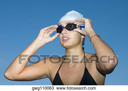 Close-up of a young woman wearing swimming goggles View Large Photo Image Stock Image - Close-up of a young woman wearing swimming goggles. Fotosearch