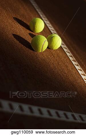 Close-up of three tennis balls in a court View Large Photo Image Stock Photo - Close-up of three tennis balls in a court. Fotosearch