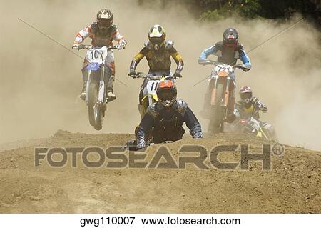 Five motocross riders riding motorcycles on a dirt road View Large Photo Image Stock Photo - Five motocross riders riding motorcycles on a dirt road. Fotosearch