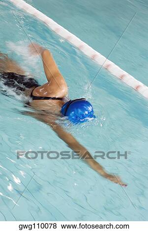 High angle view of a teenage girl swimming in a swimming pool View Large Photo Image Stock Photo - High angle view of a teenage girl swimming in a swimming pool. Fotosearch
