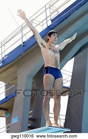 Low angle view of a mid adult man taking start from a diving platform View Large Photo Image Stock Photograph - Low angle view of a mid adult man taking start from a diving platform. Fotosearch