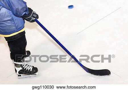 Low section view of a man playing ice hockey View Large Photo Image Stock Image - Low section view of a man playing ice hockey. Fotosearch