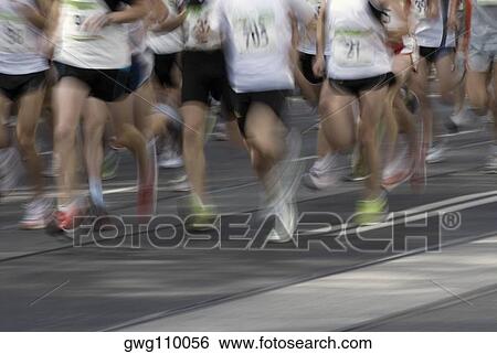 Low section view of male athletes running on a running track View Large Photo Image Stock Photograph - Low section view of male athletes running on a running track. Fotosearch