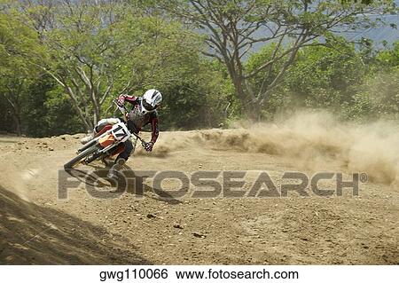 Motocross rider leaning into a turn View Large Photo Image Stock Photograph - Motocross rider leaning into a turn. Fotosearch