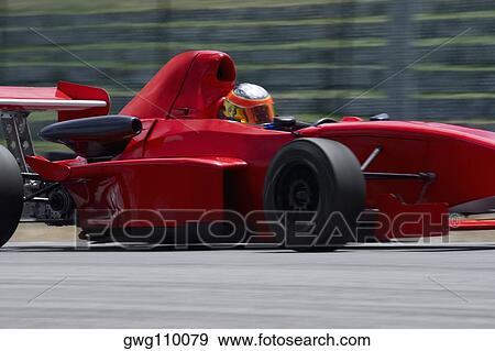 Person driving a formula one racing car on a motor racing track View Large Photo Image Stock Photo - Person driving a formula one racing car on a motor racing track. Fotosearch