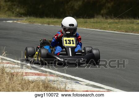 Person go-carting on a motor racing track View Large Photo Image Stock Image - Person go-carting on a motor racing track. Fotosearch