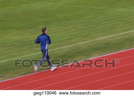 Rear view of a mid adult man running on a running track View Large Photo Image Stock Photograph - Rear view of a mid adult man running on a running track. Fotosearch