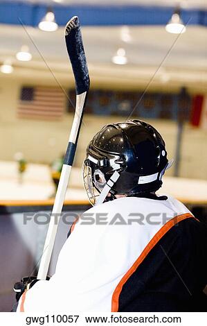 Rear view of an ice hockey player near an ice rink View Large Photo Image Stock Photo - Rear view of an ice hockey player near an ice rink. Fotosearch