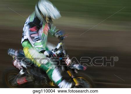 Side profile of a man riding a motorcycle in a sports race View Large Photo Image Picture - Side profile of a man riding a motorcycle in a sports race. Fotosearch