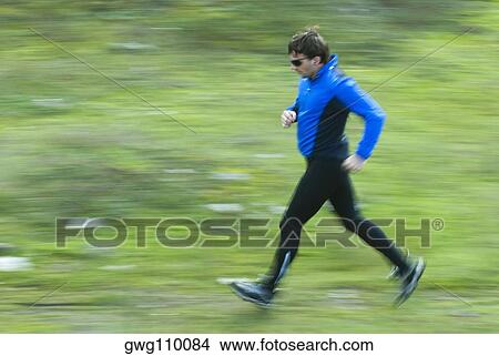 Side profile of a mid adult man jogging View Large Photo Image Picture - Side profile of a mid adult man jogging. Fotosearch