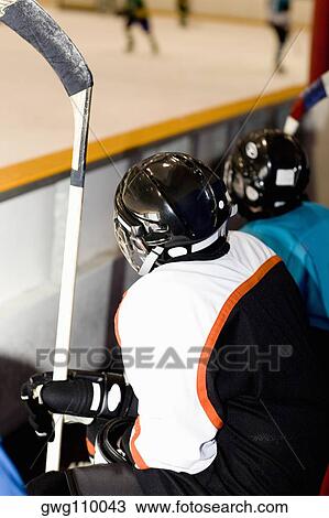 Two ice hockey players watching ice hockey View Large Photo Image Stock Image - Two ice hockey players watching ice hockey. Fotosearch
