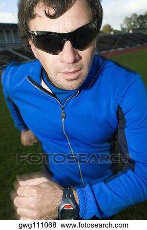 Stock Photo - Close-up of a mid adult man running. Fotosearch