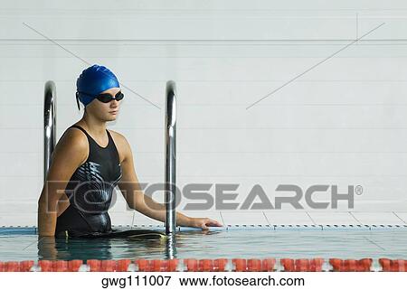 Stock Photo - Close-up of a teenage girl standing in a swimming pool. Fotosearch