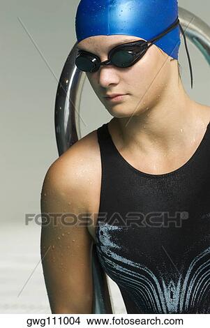Close-up of a teenage girl wearing a swimming cap and swimming goggles View Large Photo Image Picture - Close-up of a teenage girl wearing a swimming cap and swimming goggles. Fotosearch