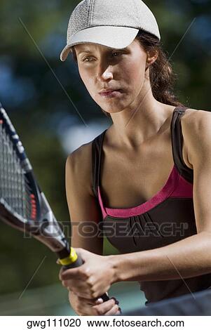 Close-up of a young woman playing with a tennis racket View Large Photo Image Stock Image - Close-up of a young woman playing with a tennis racket. Fotosearch